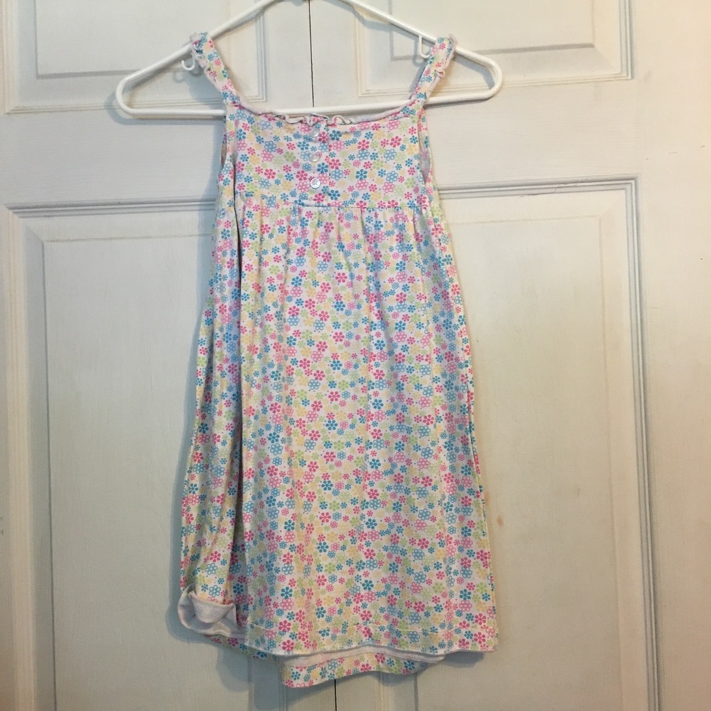 White dress with frills at the collar and flowers